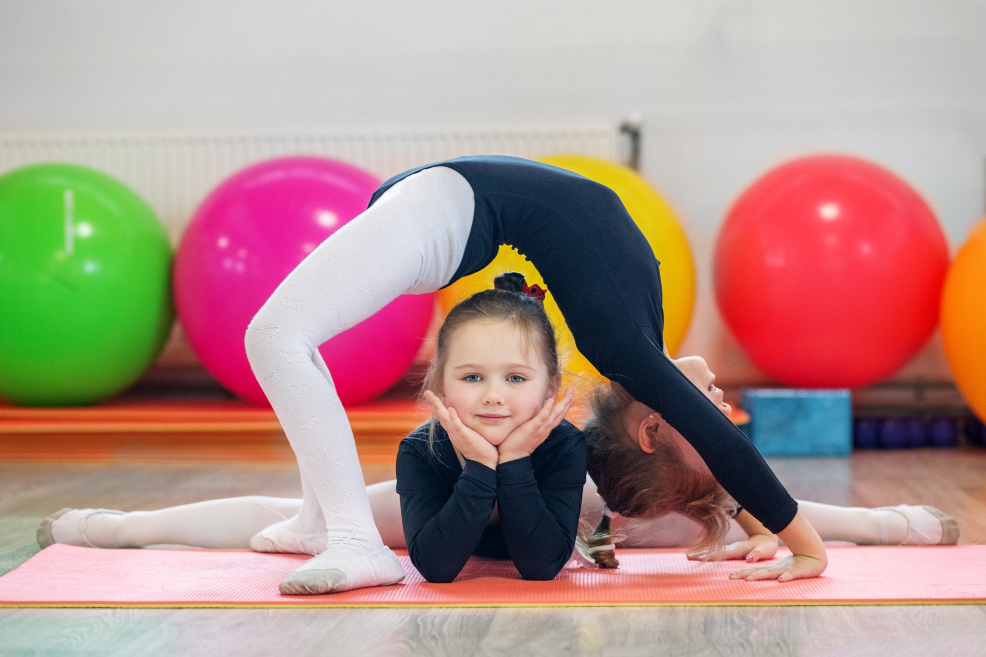 Two young children train in a gym class. The concept of sport, education, childhood